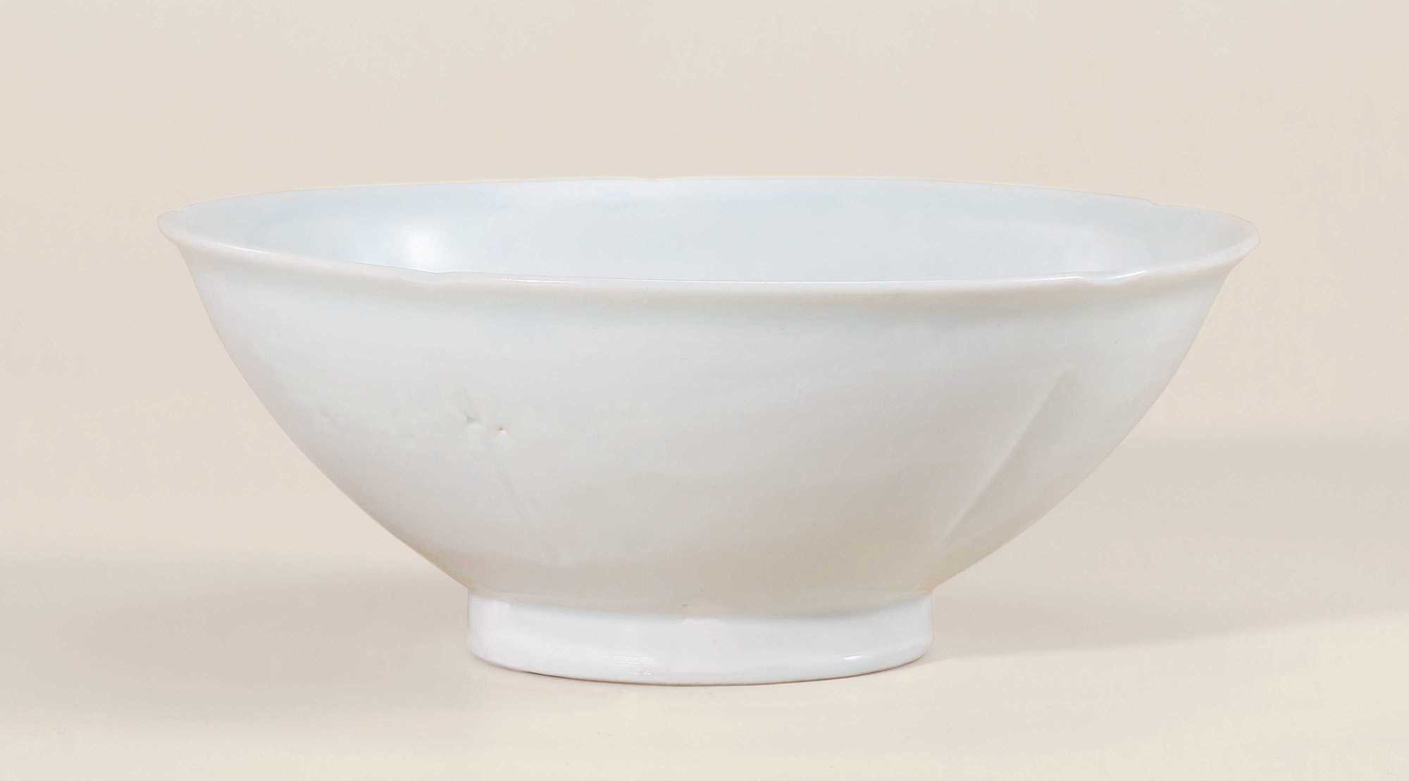 A WHITE GLAZED FLORAL-SHAPED BOWL