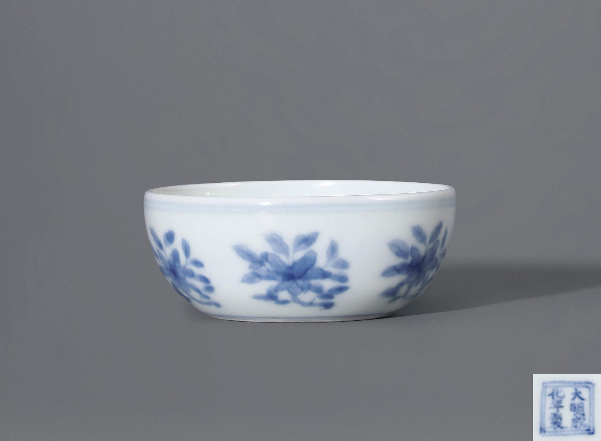 An extremely rare blue and white cup with inward foot and design of branched flowers