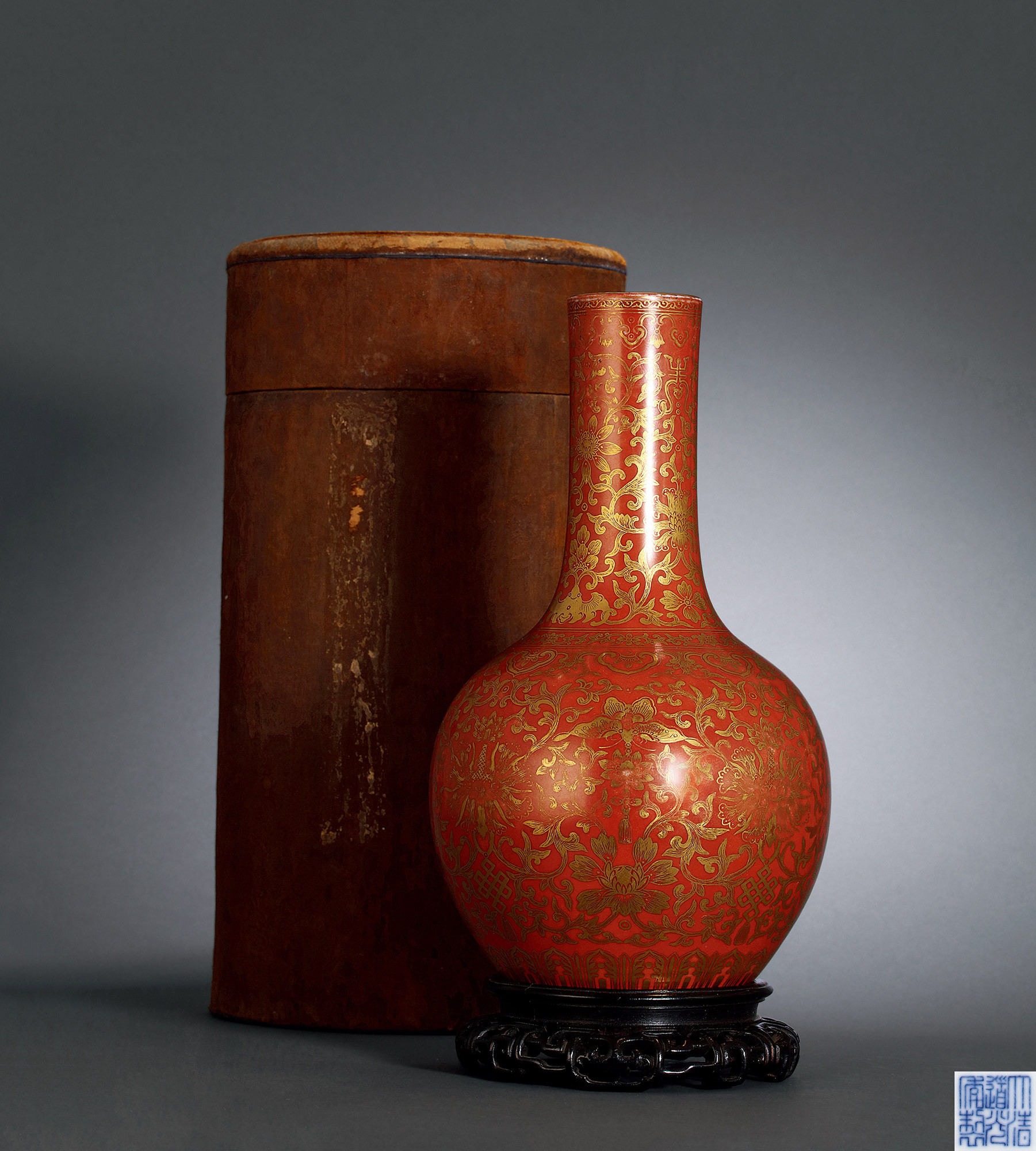 A CORAL GROUND GILTED VASE