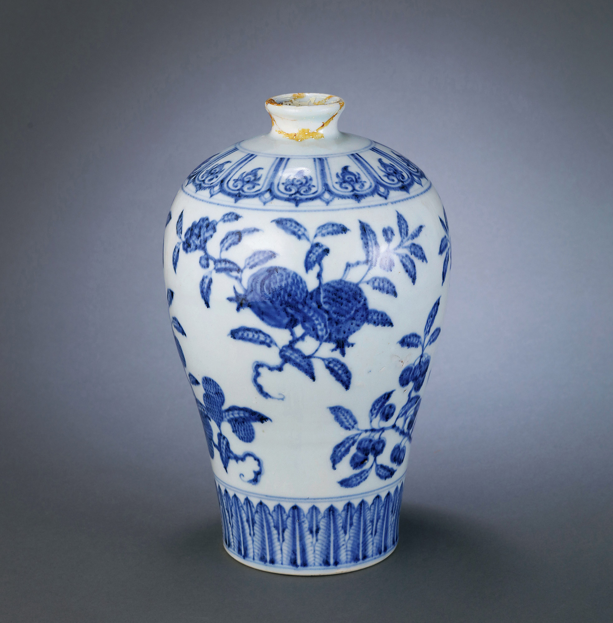 A BLUE AND WHITE FLOWERS AND FRUITS VASE