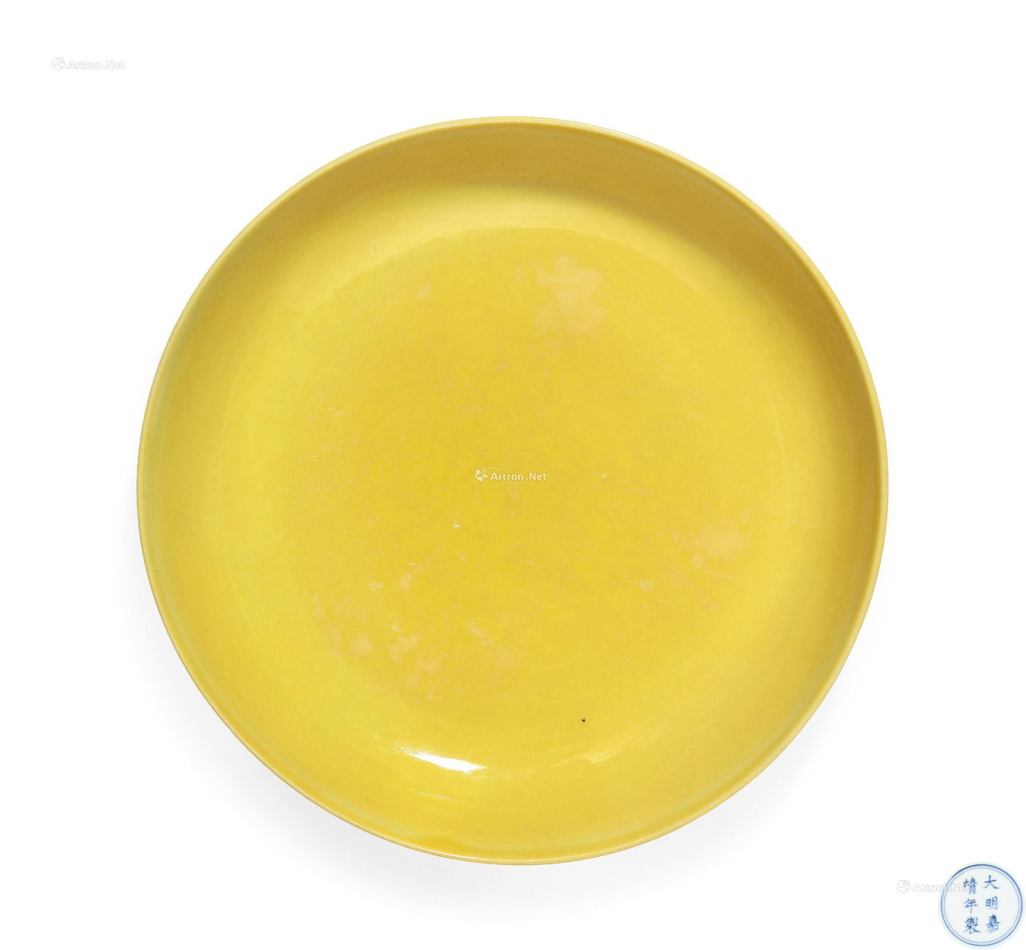 A BRIGHT YELLOW GLAZED PLATE