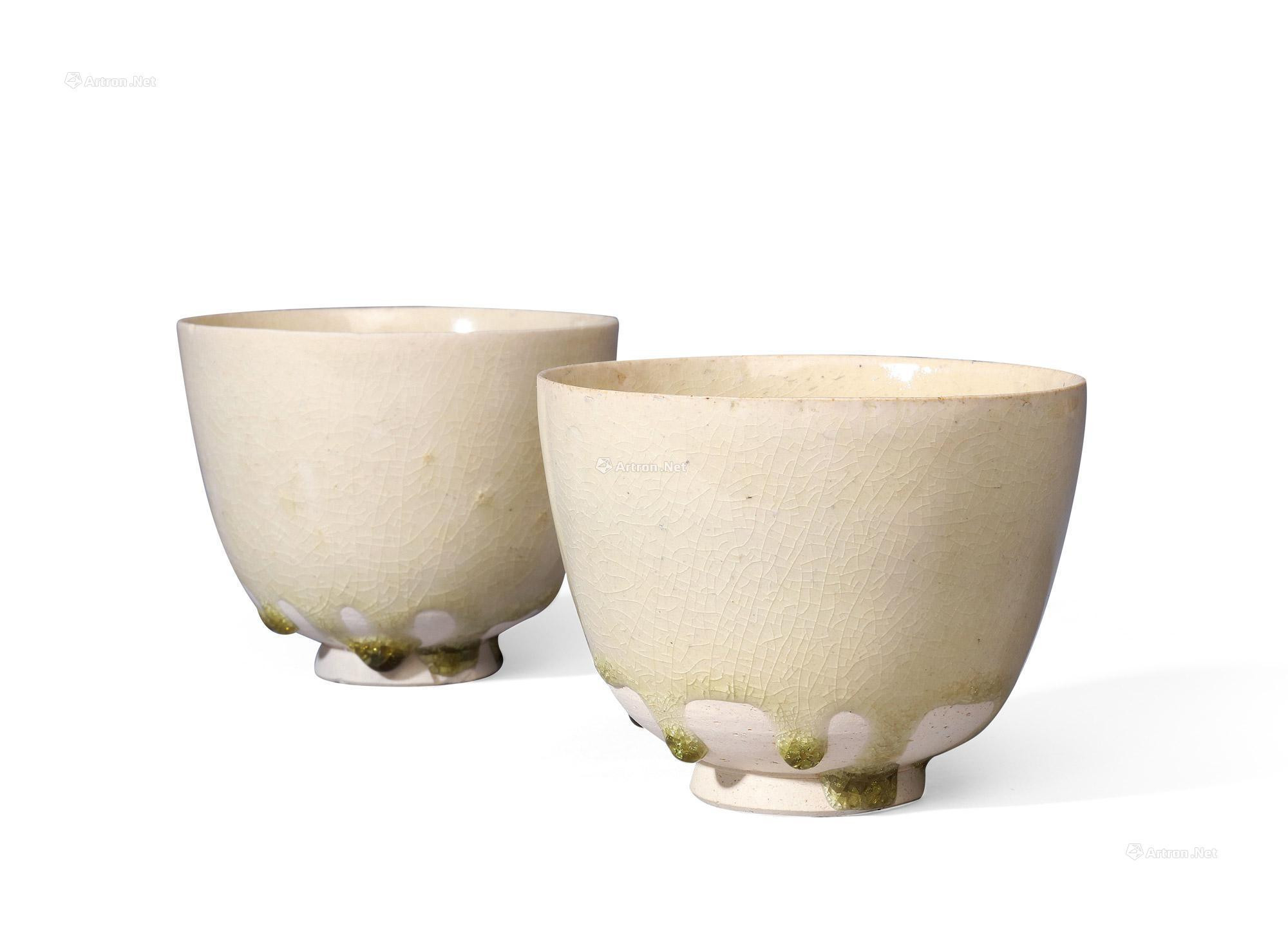 A PAIR OF WHITE-GLAZED CUPS