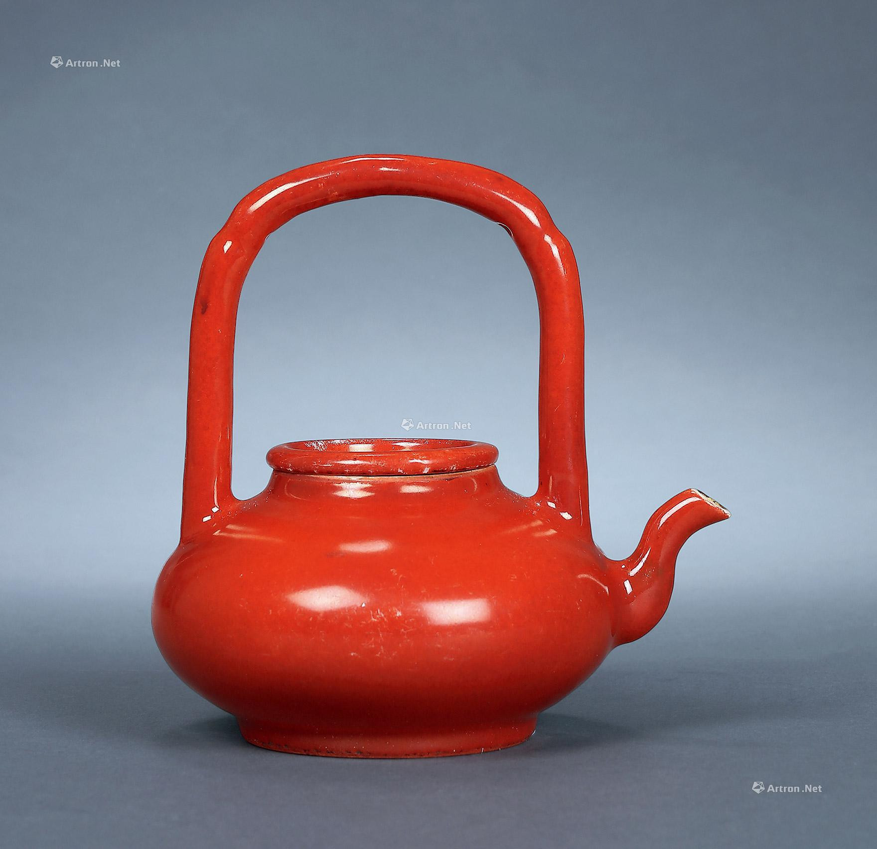 A CORAL GLAZED LOOP-HANDLED TEAPOT
