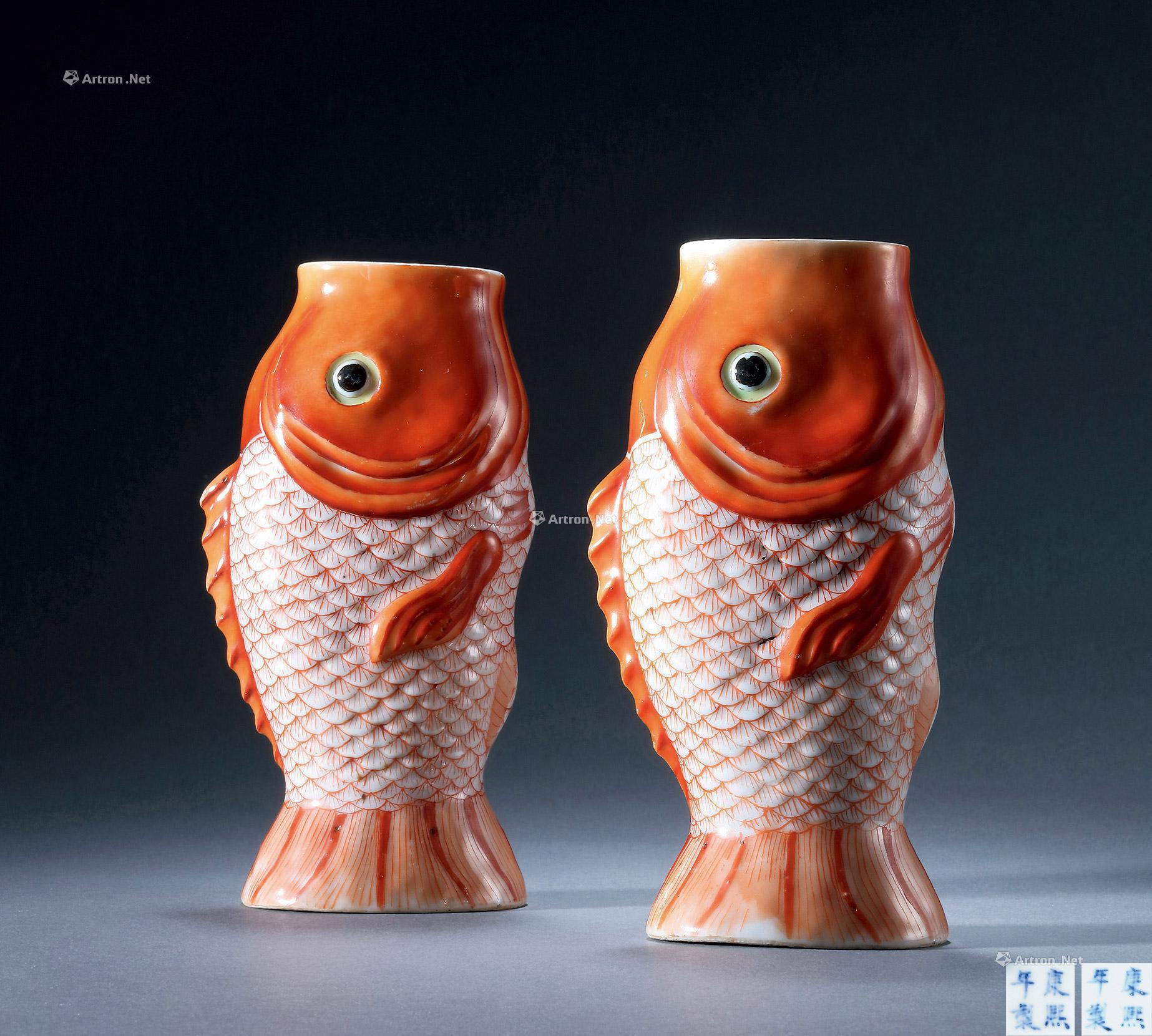 A PAIR OF IRON-RED  FISH-SHAPED FLOWER RECEPTACLE