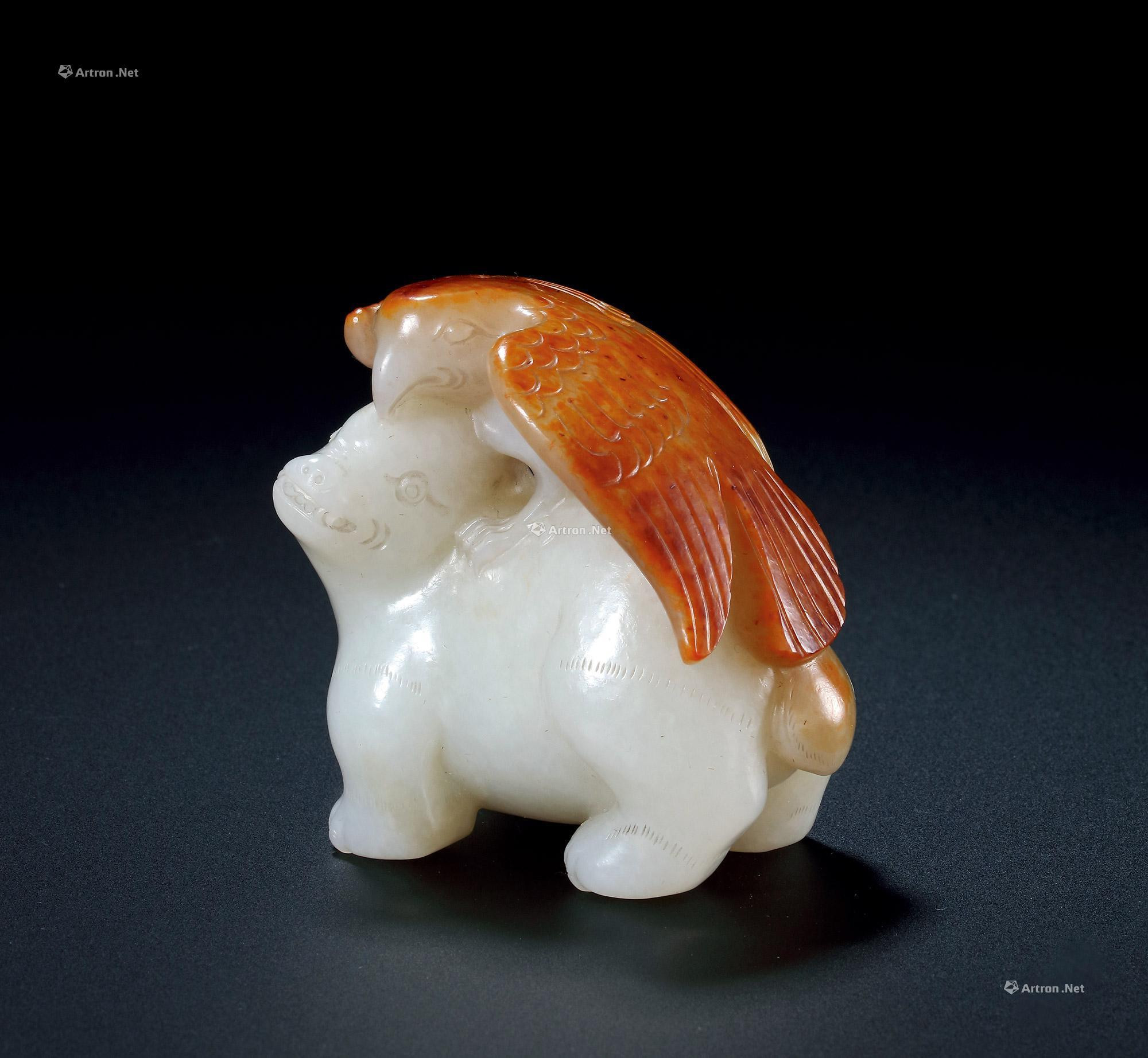 A WHITE AND RUSSET JADE FIGURE OF HAWK AND BEAST