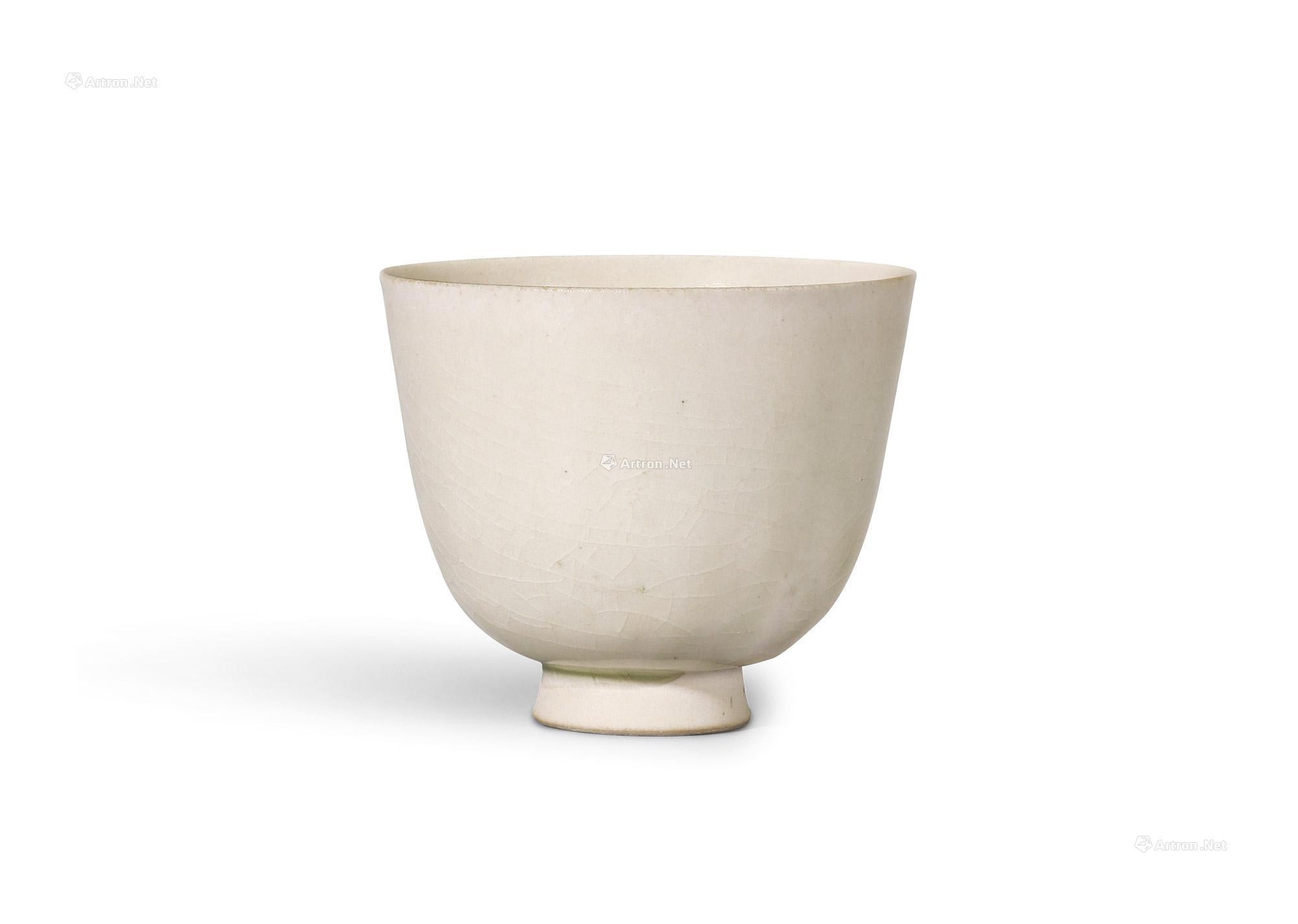 A WHITE GLAZED CUP