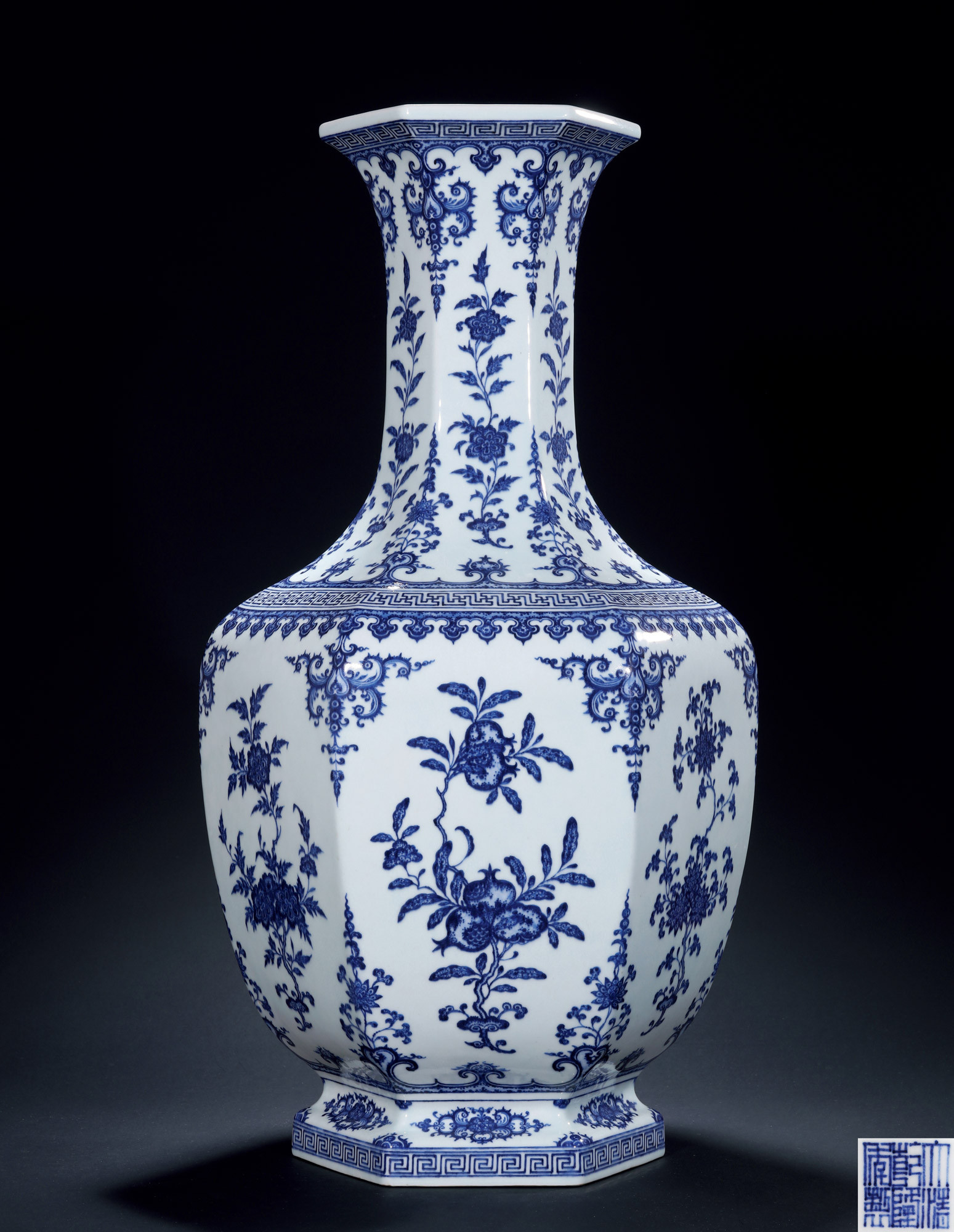 A BLUE-AND-WHITE FLOWER AND FRUITS AMONG LEAVES HEXAGONAL VASE