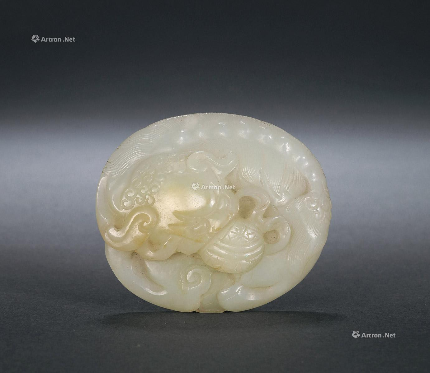 A CARVED GREENISH WHITE JADE BELT HOOK WITH DESIGN OF LION AND BALL