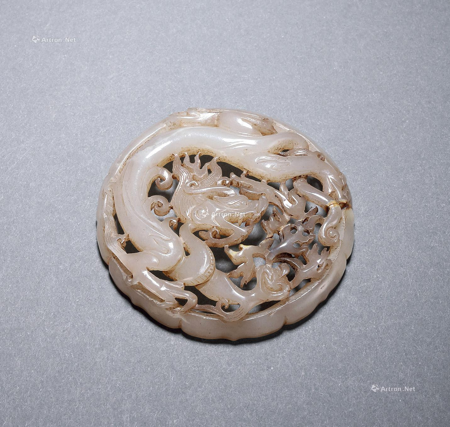 A PIERCED AND CARVED GREENISH JADE PENDANT WITH DESIGN OF DRAGON