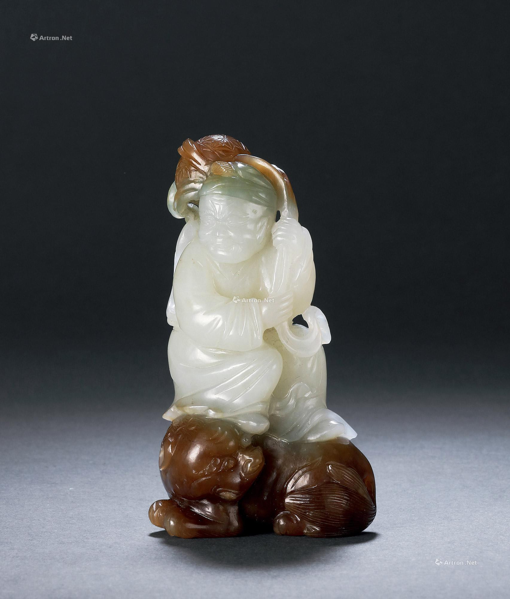 A CARVED WHITE JADE FIGURE AND LION