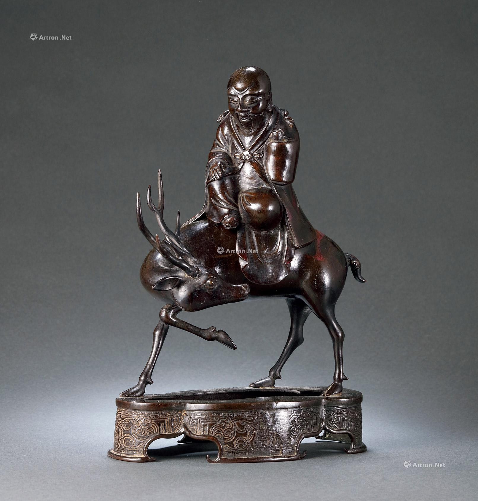 A BRONZE INCENSE BURNER WITH THE PATTERN OF A SHOLAR RIDING A DEER