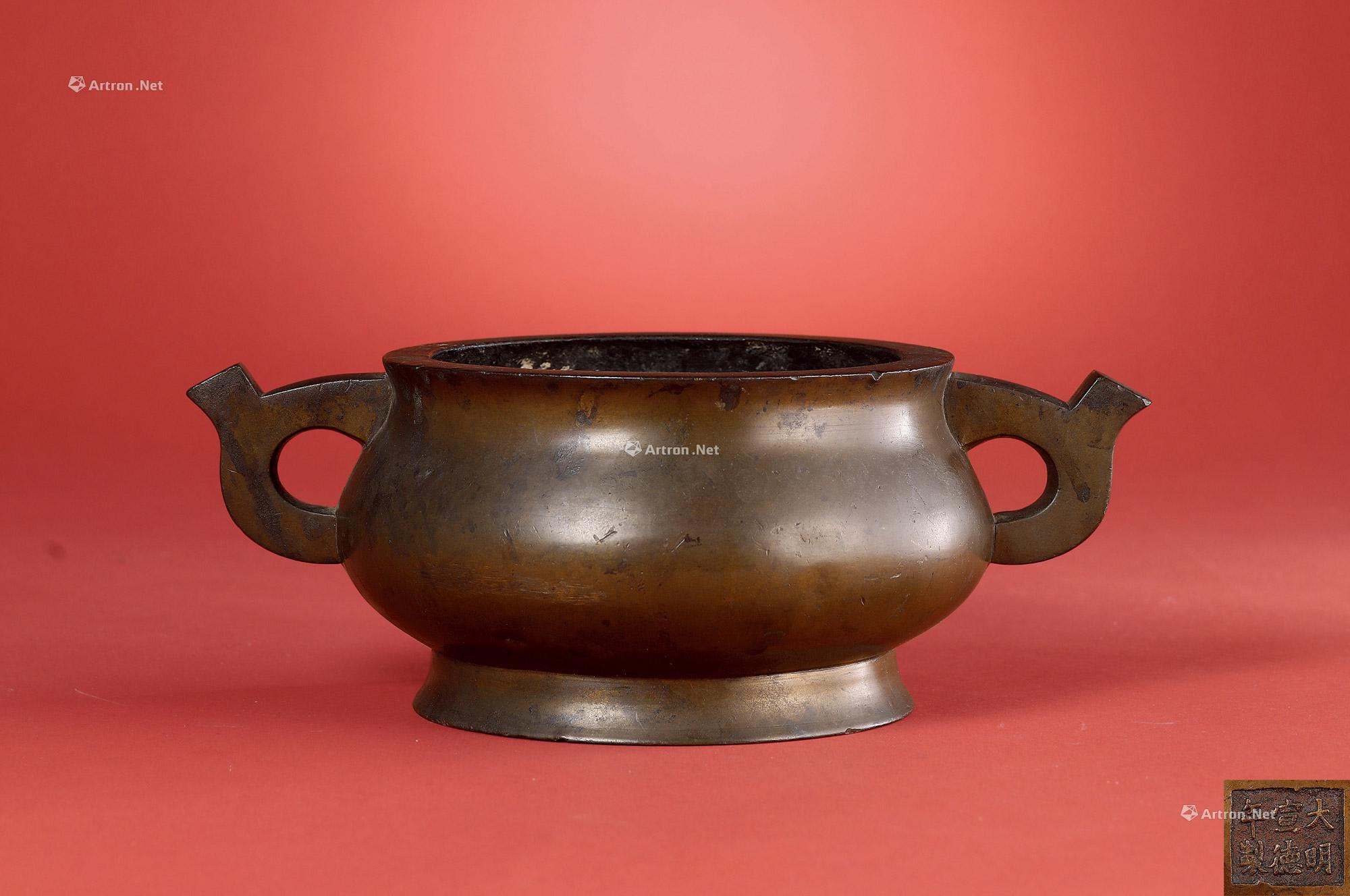 A BRONZE INCENSE BURNER WITH DOUBLE EARS