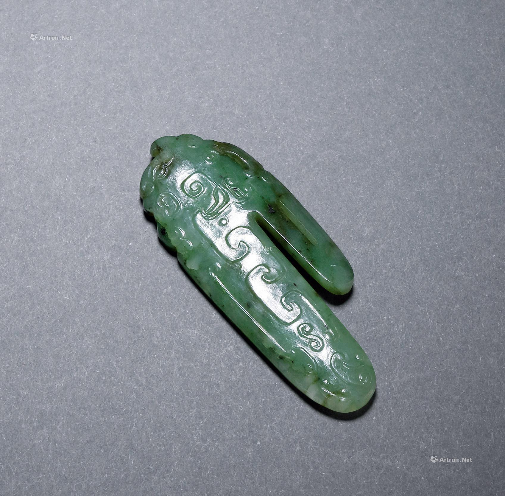 A CARVED greenish white jade OLD-STYLE BUCKLE