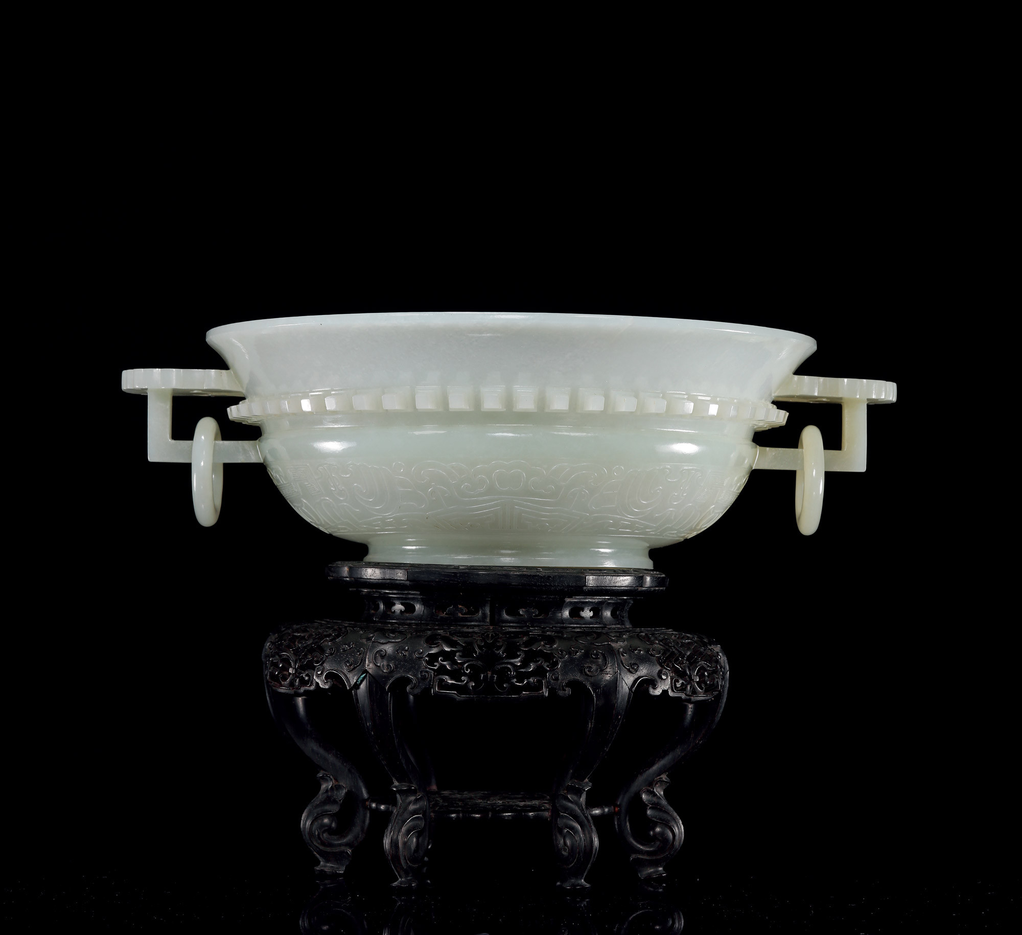 A CARVED WHITE JADE ‘BATS’ WASHER