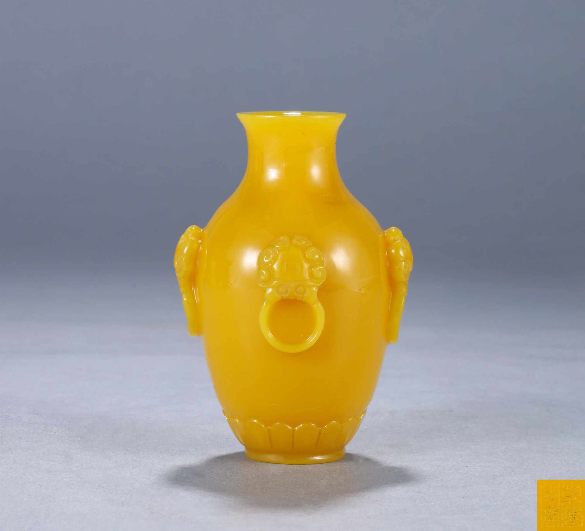 A YELLOW GLASS VASE
