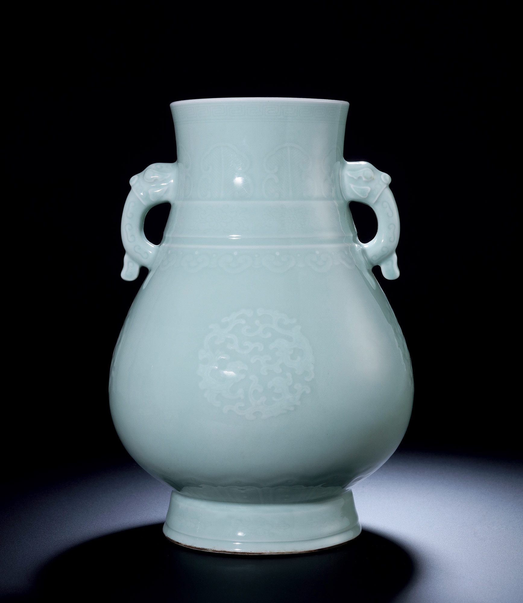 A CELADON-GLAZED WITH MOULDED “DRAGON” vase