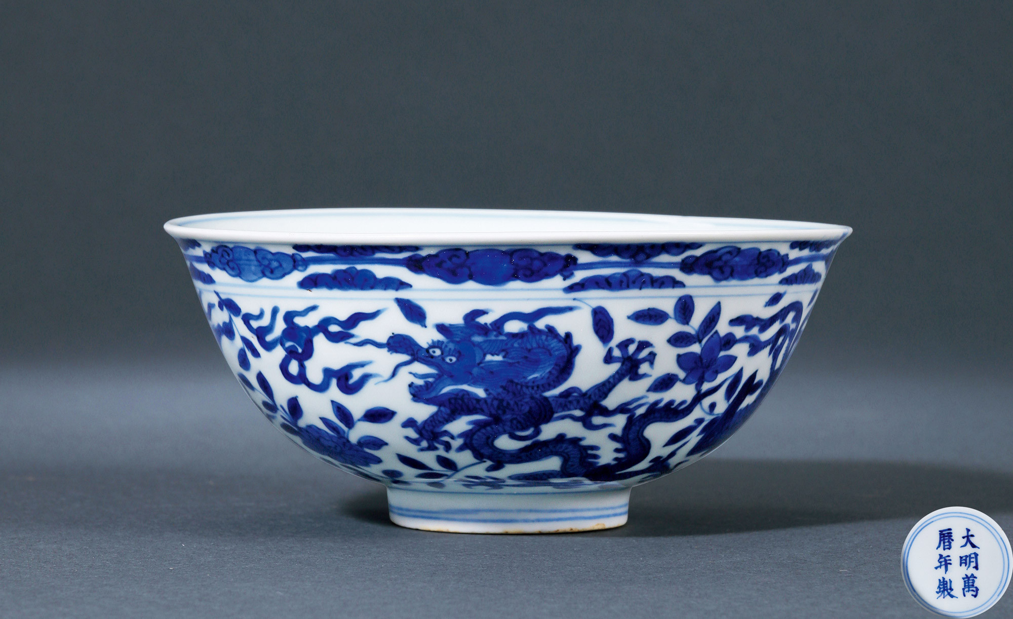 A BLUE AND WHTE BOWL WITH DRAGON AND PHEONIX DESIGN
