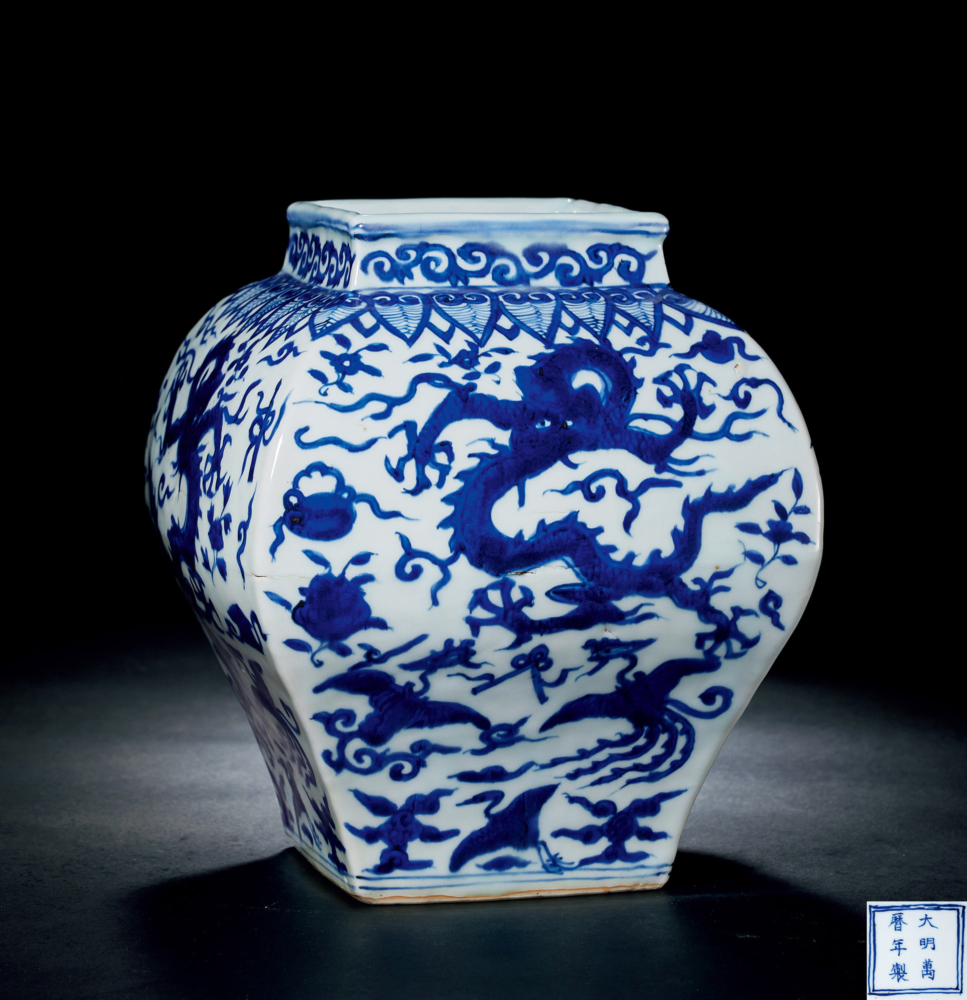 A BLUE AND WHITE SQUARE JAR WITH MYSTICAL BEASTS DESIGN