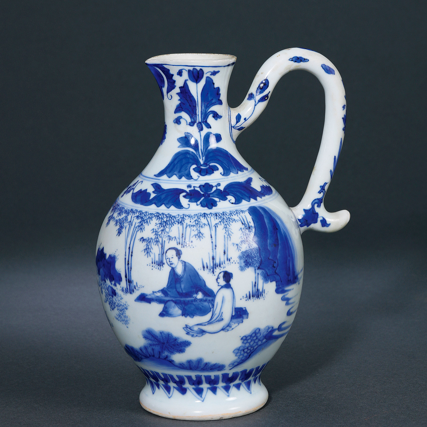 A BLUE AND WHITE EWER WITH HANDLE AT A SIDE