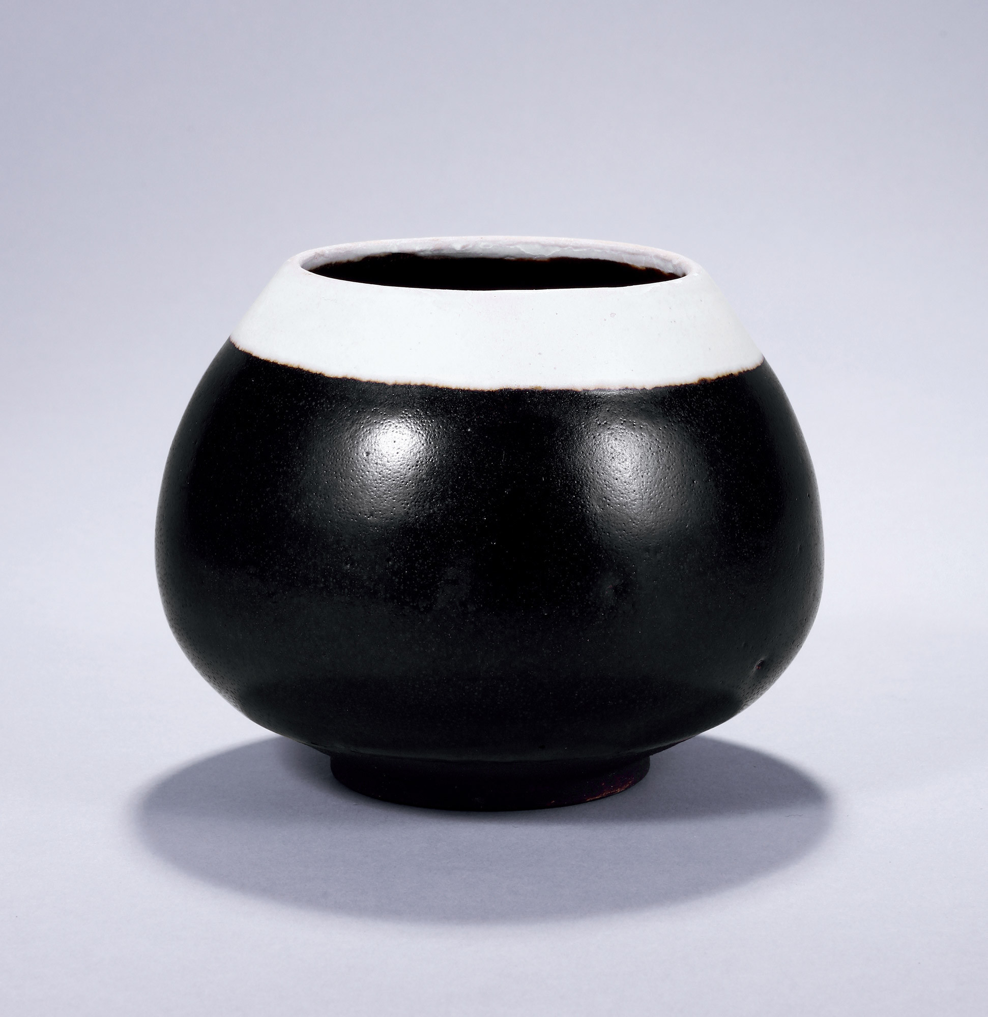 A BLACK GLAZE WATER CONTAINER