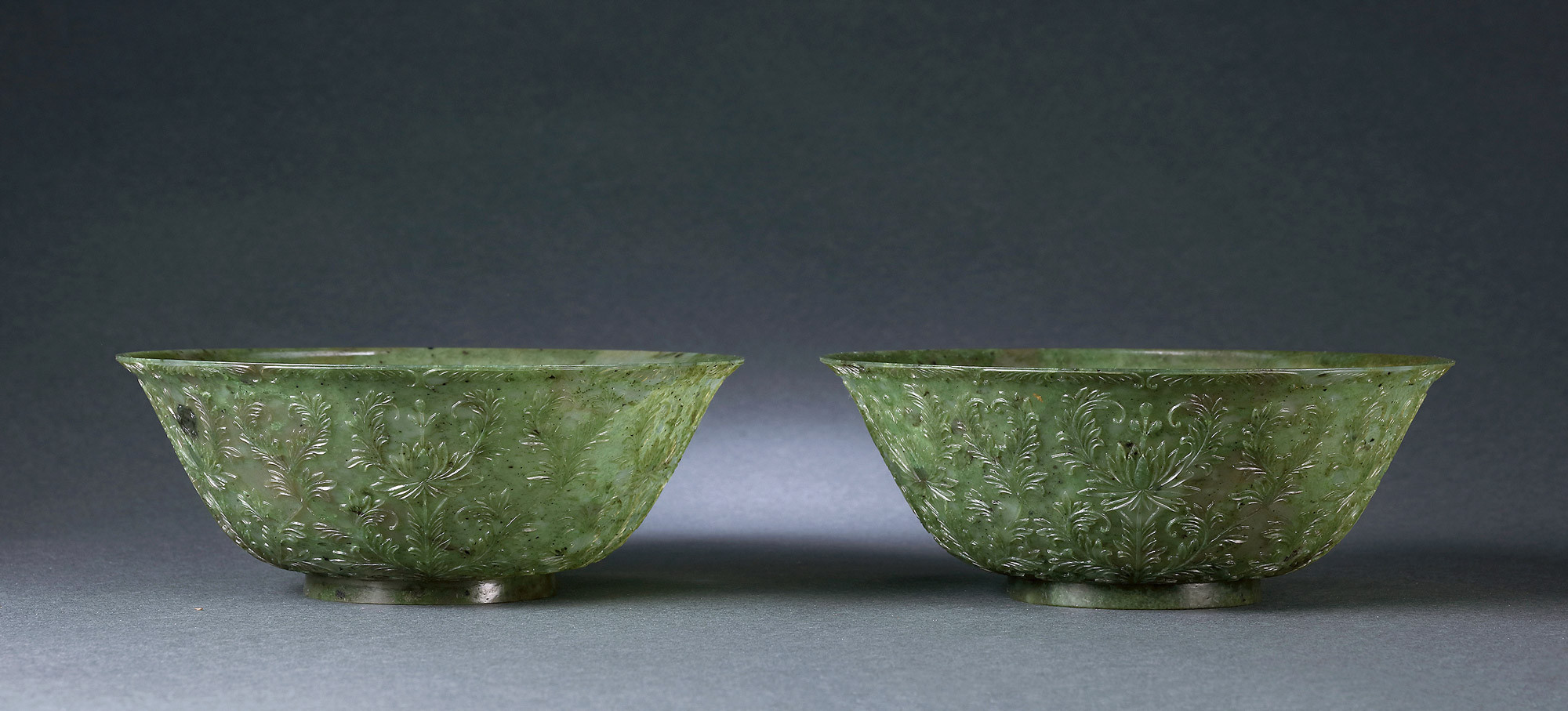 A PAIR OF HINDUSTAN-TYPE ‘FLORAL AND PLANT’ GREENISH JADE BOWLS