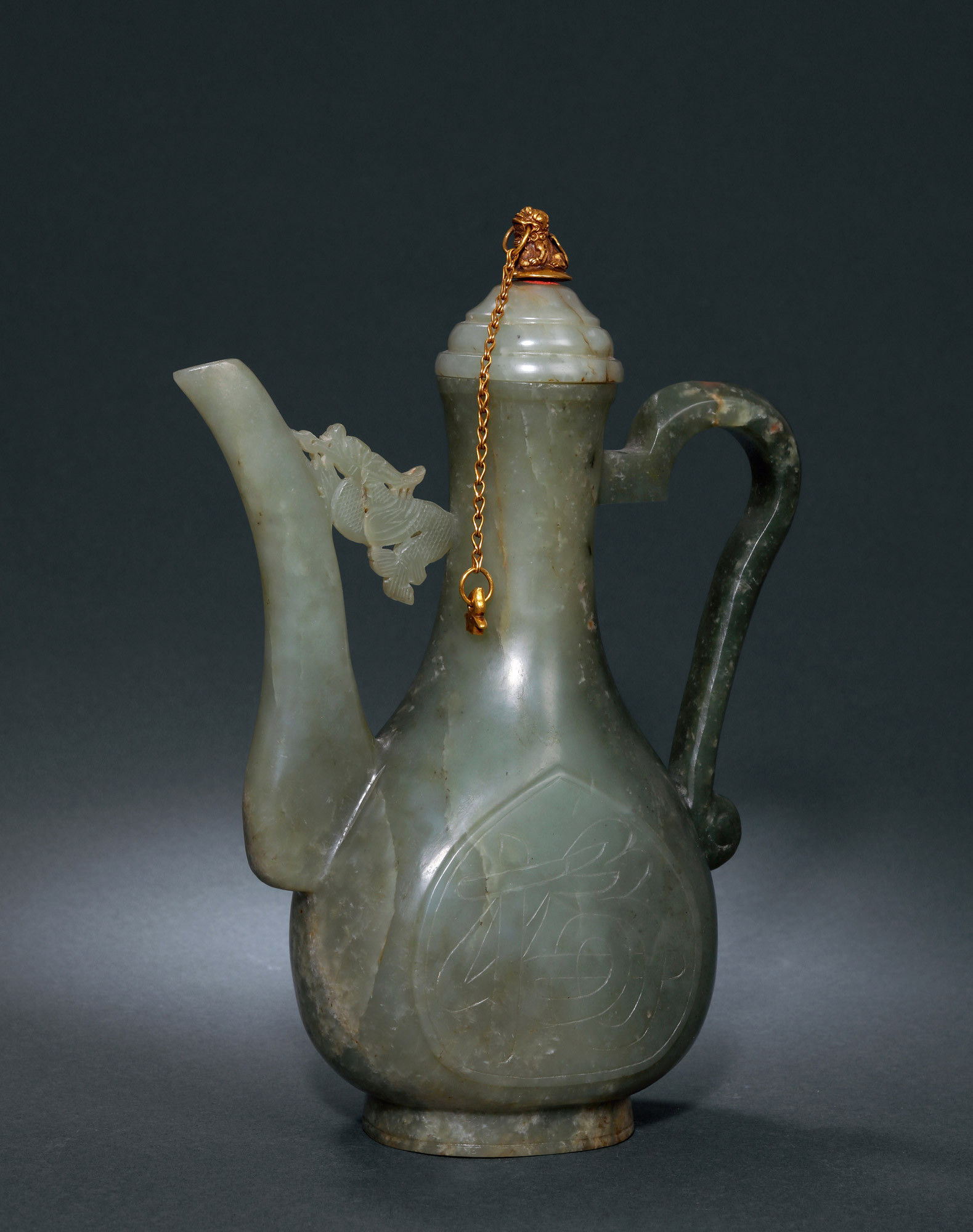 A CARVED GREENISH JADE EWER WITH HANDLE