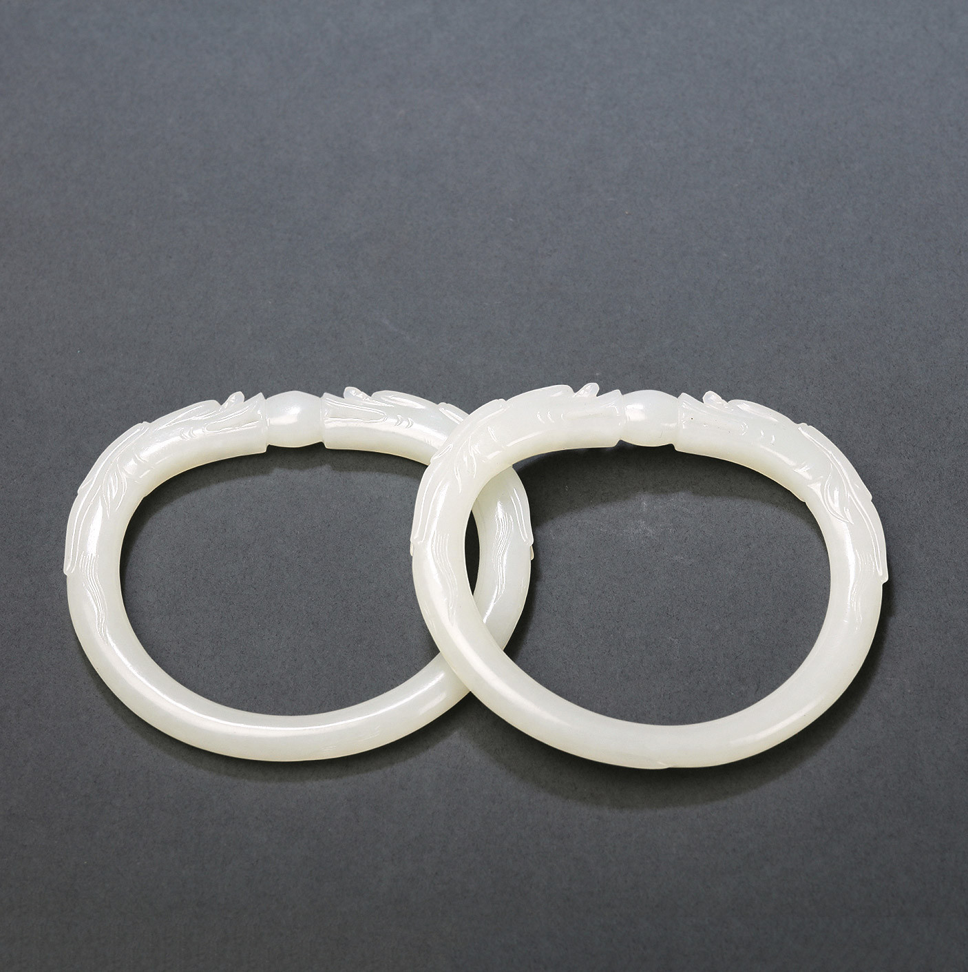 A PAIR OF WHITE JADE‘DRAGONS AND BALLS’BRACELETS