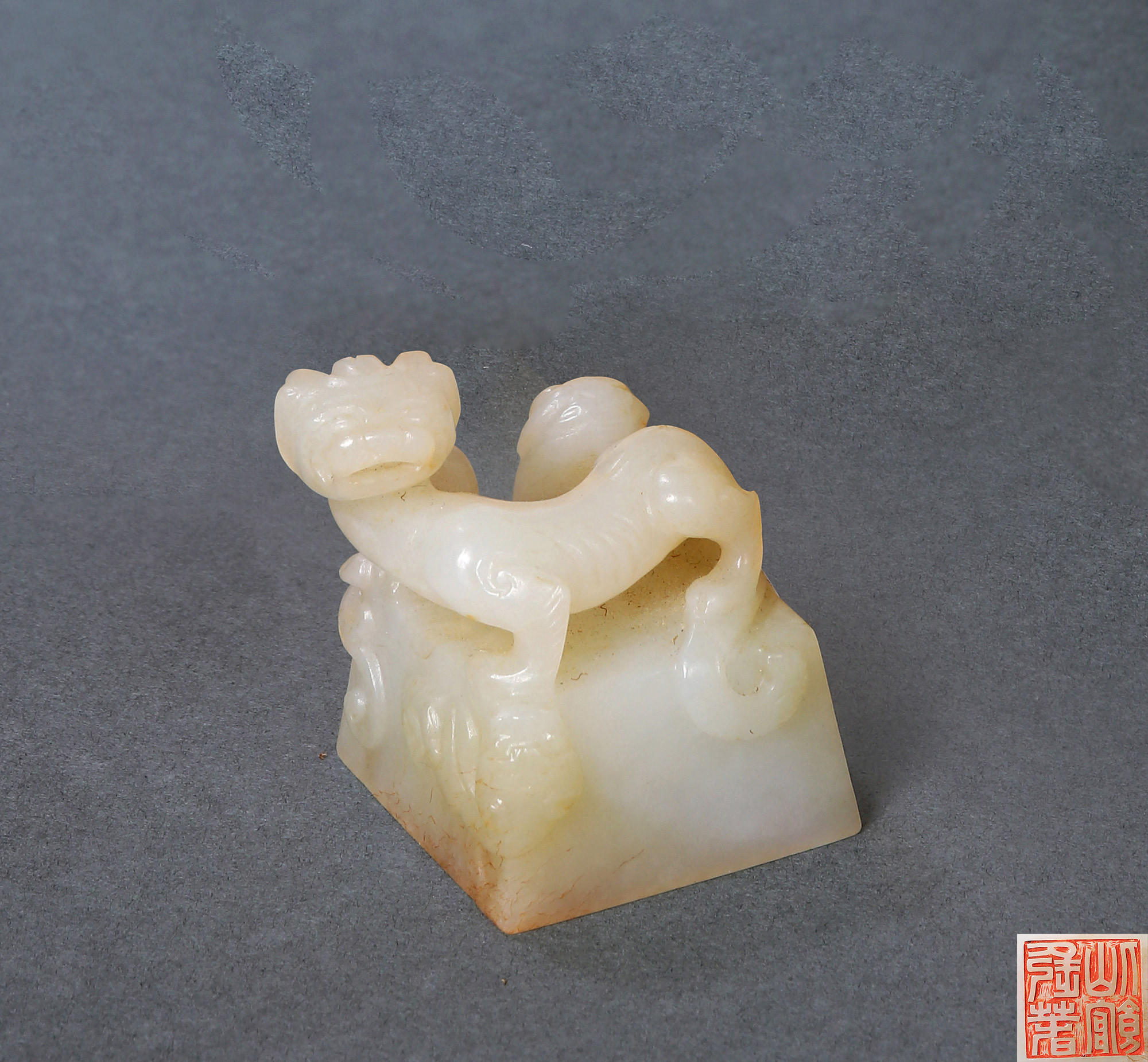 A WHITE JADE SQUARE SEAL WITH DRAGON-KNOB