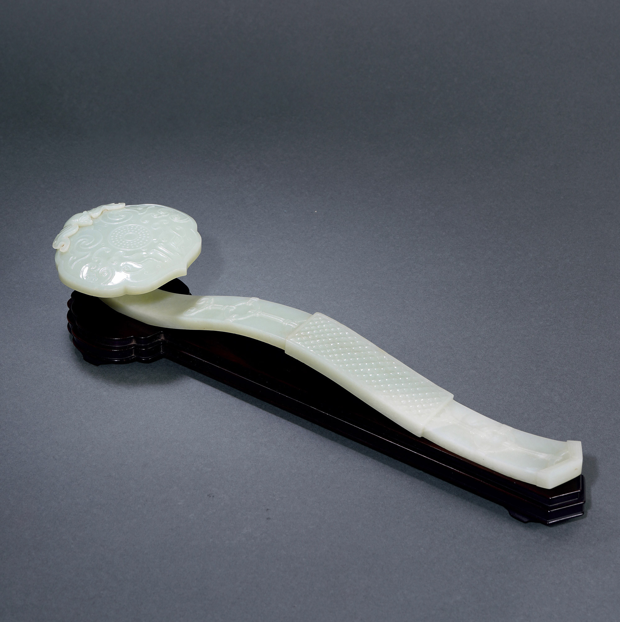 A CARVED GREEN-WHITE JADE‘FORTUNE IS COMING’RUYI WITH MYSTICAL BEAST DESIGN