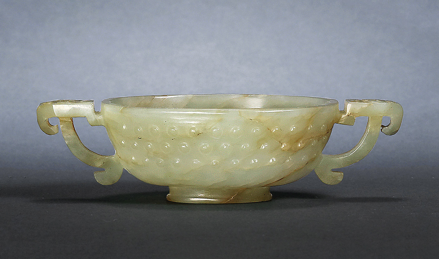 A GREEN-WHITE JADE CUP WITH HANDLES