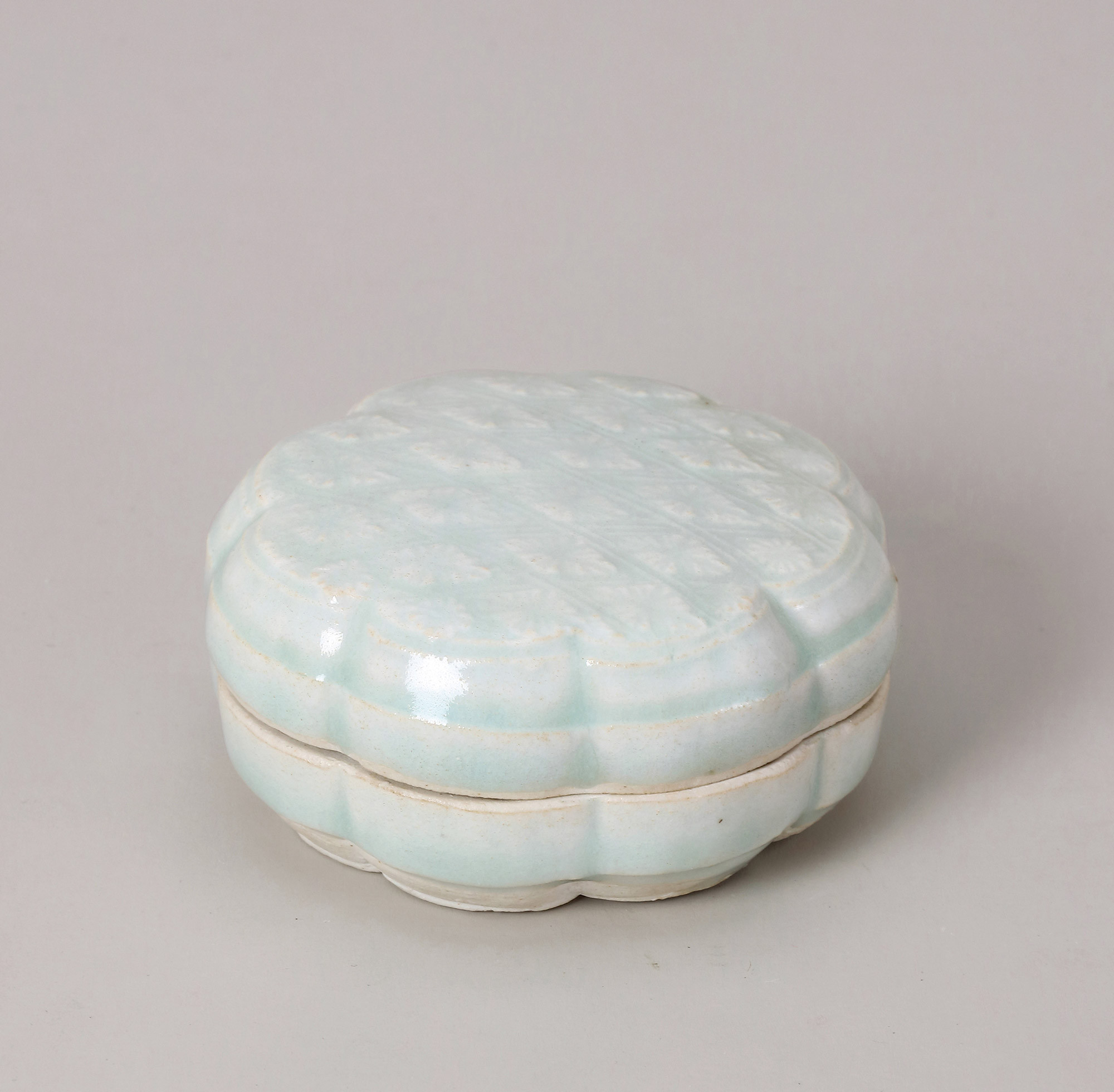 A SHADOWY-BLUE GLAZED BOX AND COVER WITH MOULDED‘FLORAL’