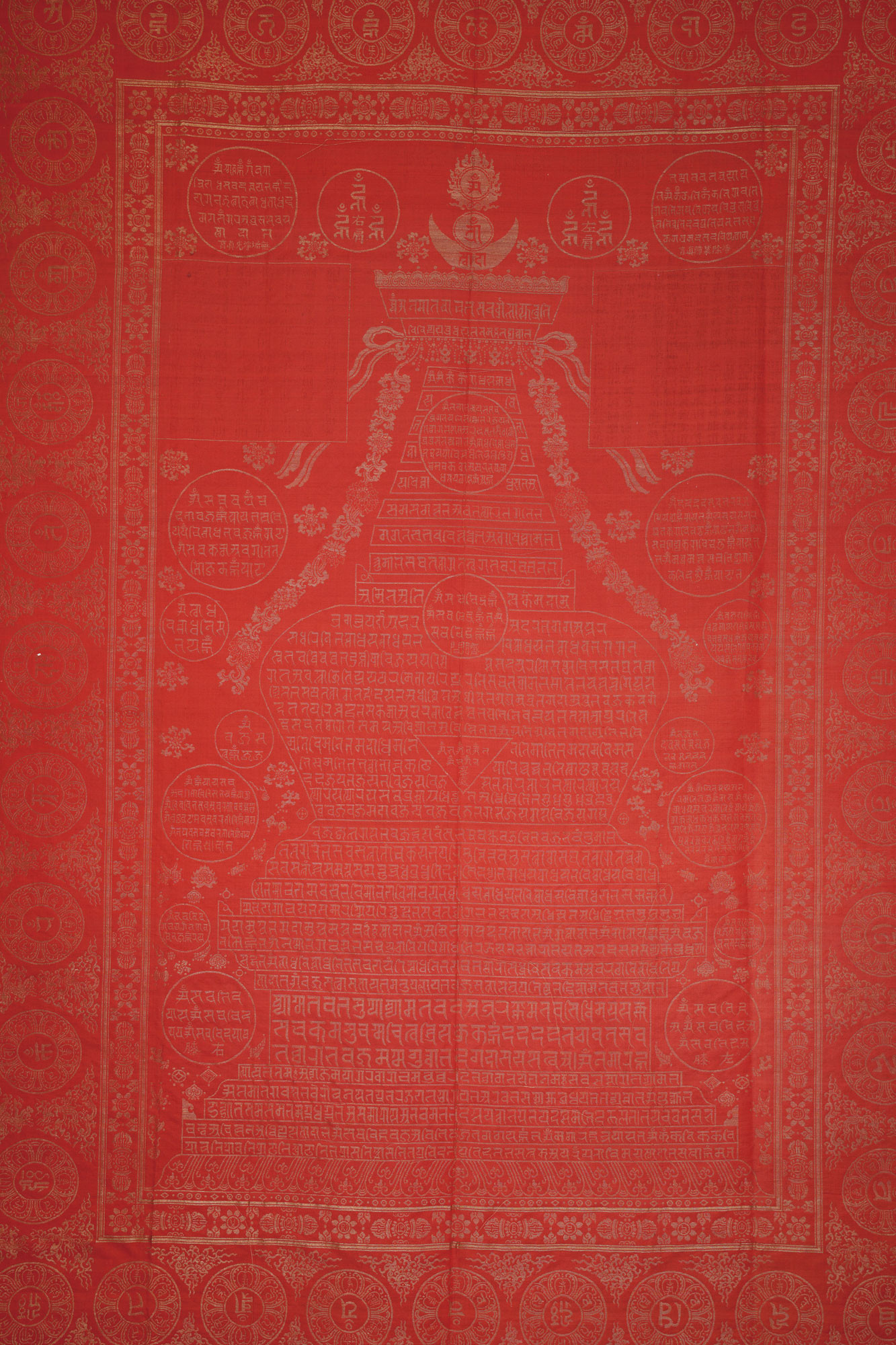 A GOLD-EMBROIDERED RED DHARANI SUTRA QUILT