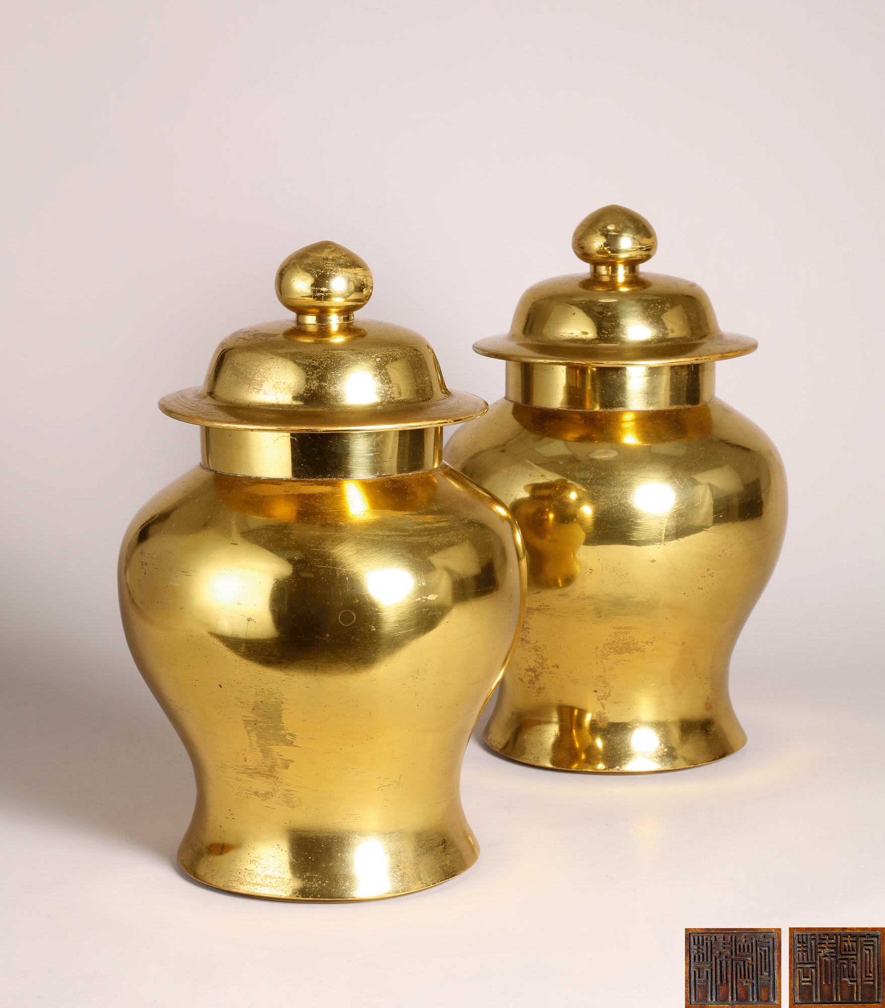 A PAIR OF GILT-BRONZE JARS WITH COVER