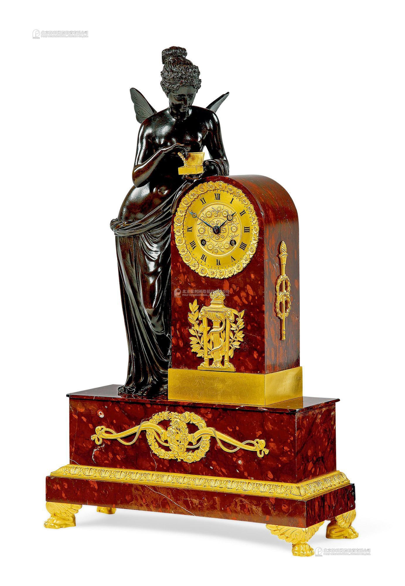 A FRENCH RED MARBLE AND GILT BRONZE FIGURAL MANTEL CLOCK