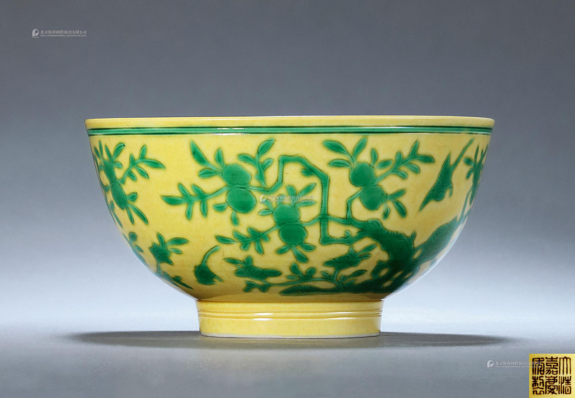 A YELLOW-GROUND AND GREEN GLAZED FLOWERS AND BIRDS BOWL