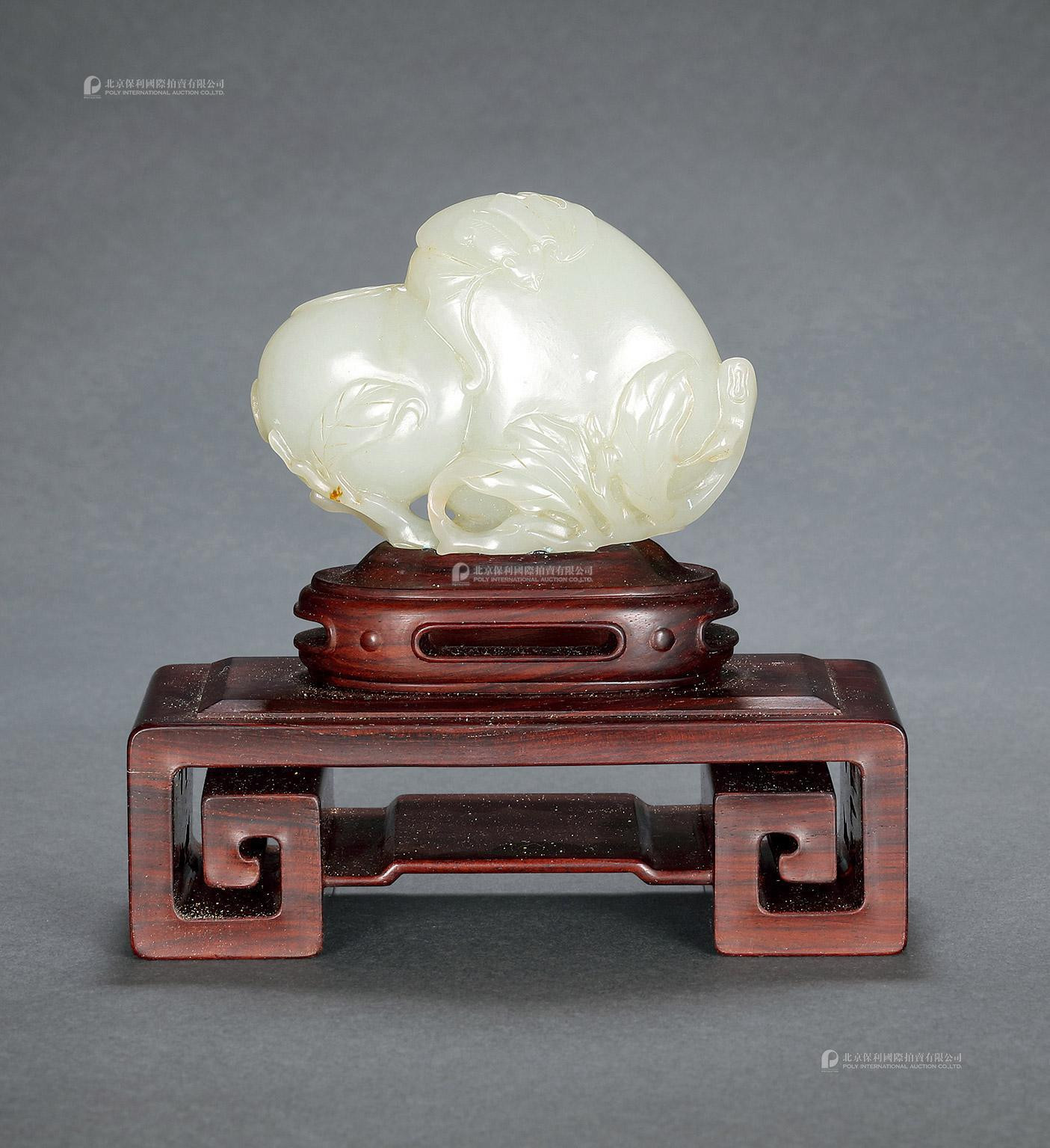 A CARVED GREENISH WHITE JADE ORNAMENTS