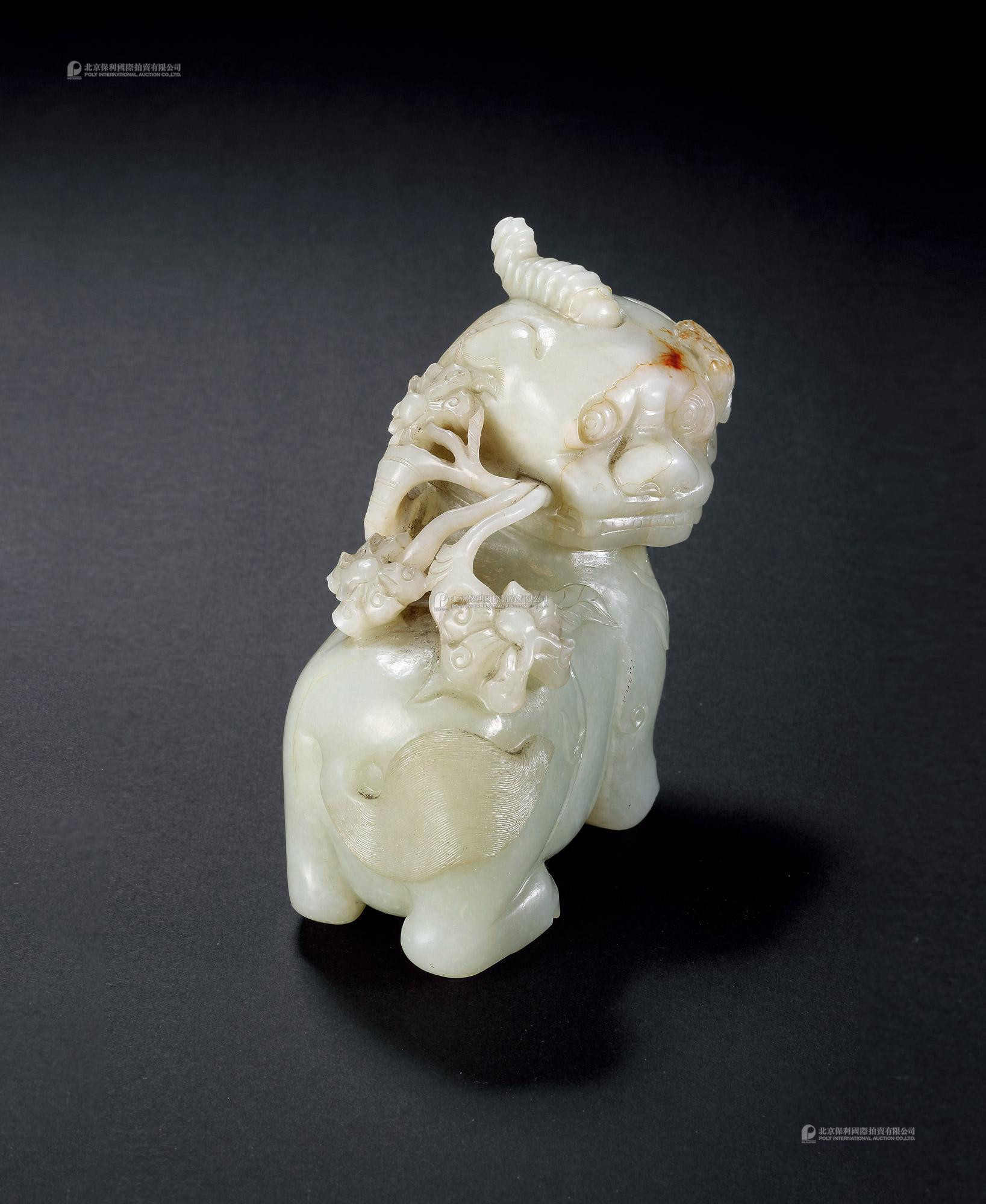 A GREENISH WHITE JADE MYTHICAL BEAST WITH LOTUS