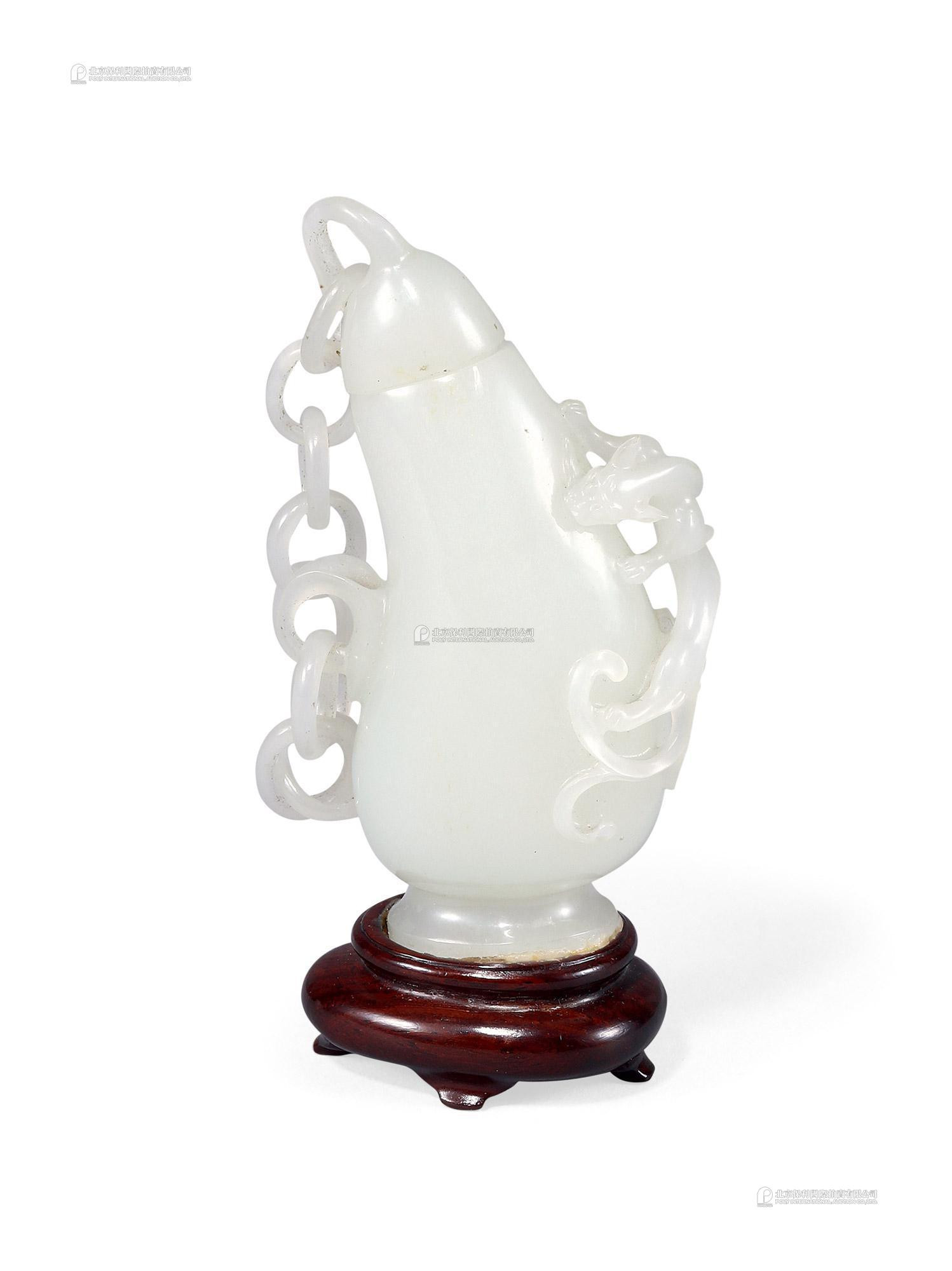 A PIERCED AND CARVED WHITE JADE HANGING VASE WITH DRAGON HANDLE