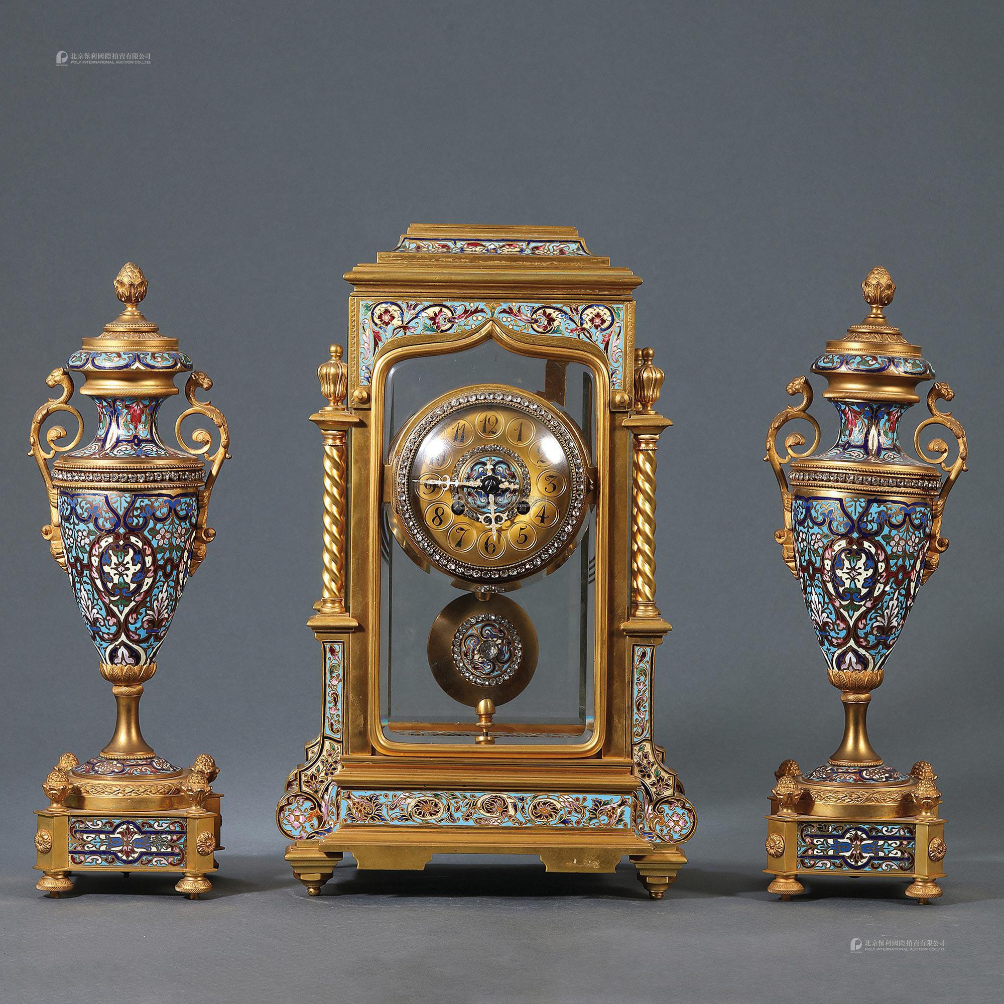A SET OF THREE GILT-ENAMELED CLOCK AND VASES